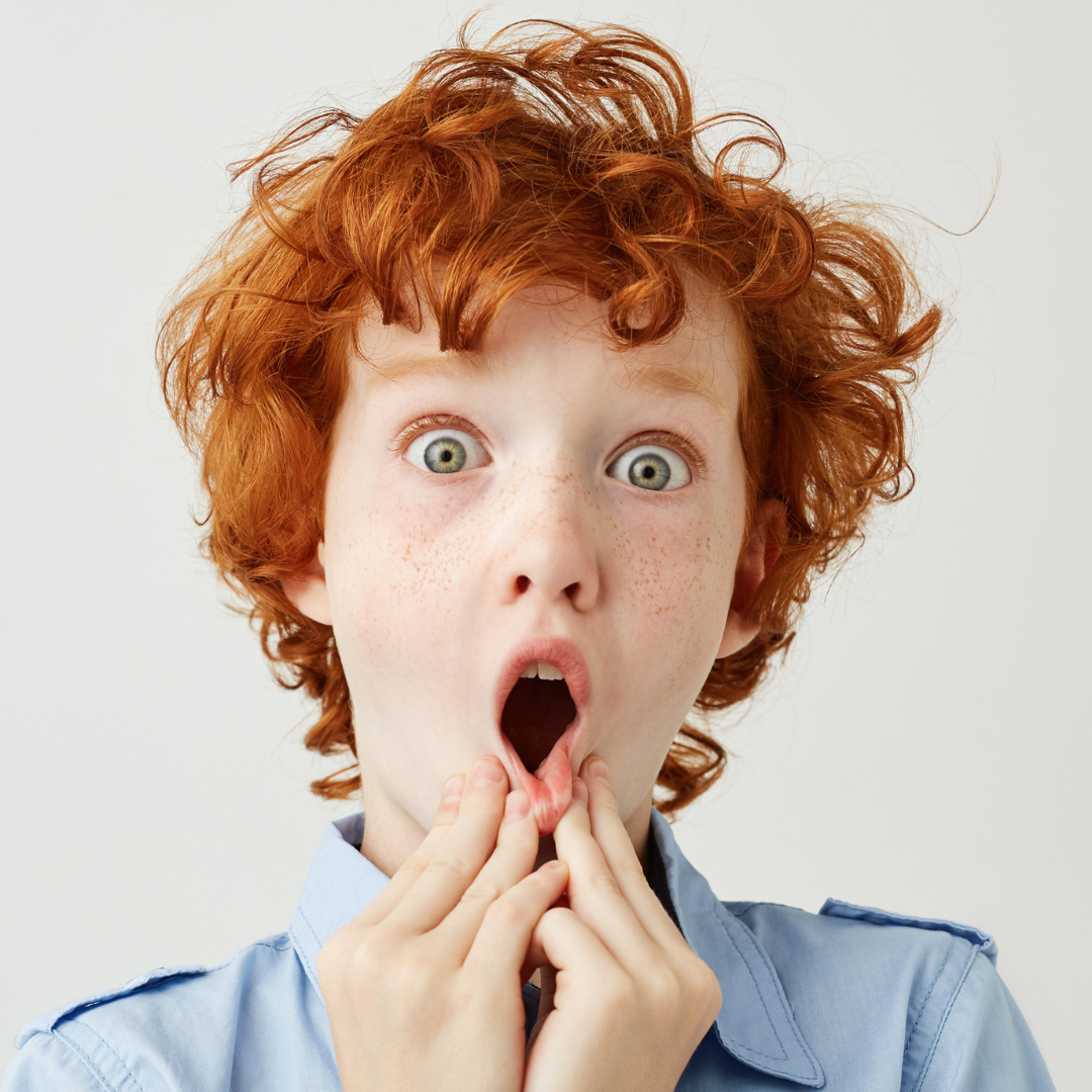 Child with eyes wide open, surprised — naming what we feel